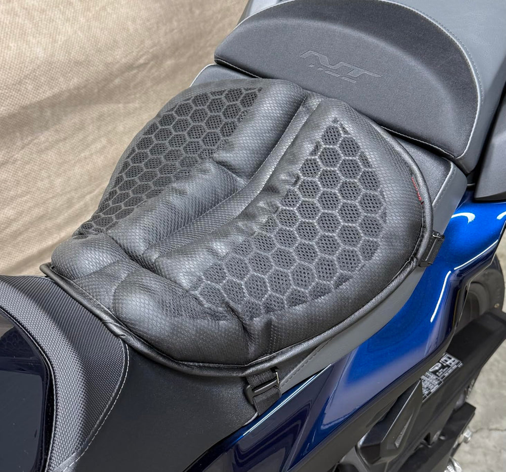 Top view of the black honeycomb gel cushion fitted to a blue motorcycle's rider seat